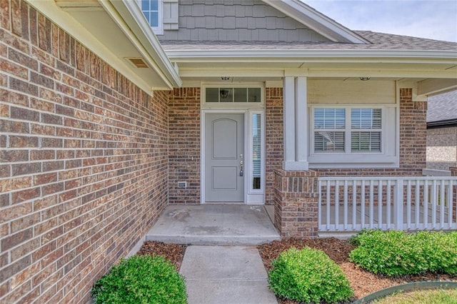 6712 NW 155th St, Edmond, OK 73013 - property entrance featuring brick siding and roof with shingles
