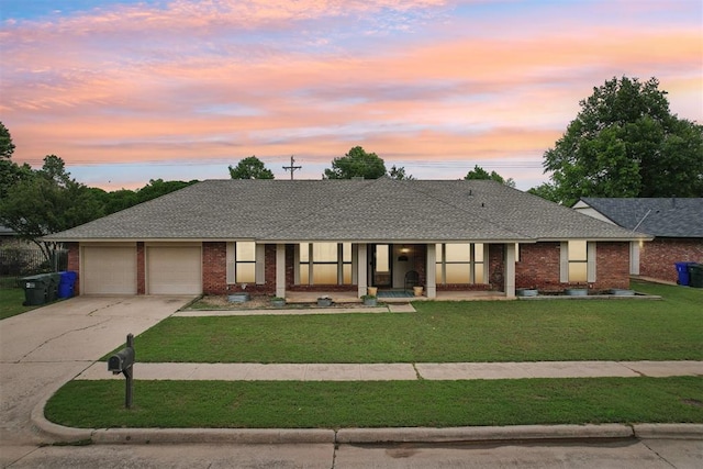 4211 Blue Sage Rd, Norman, OK 73072 - ranch-style house with a yard, an attached garage, driveway, covered porch, and brick siding