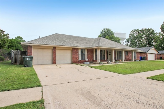 4211 Blue Sage Rd, Norman, OK 73072 - ranch-style house featuring a garage, brick siding, concrete driveway, and covered porch
