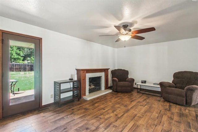 4211 Blue Sage Rd, Norman, OK 73072 - living area featuring wood finished floors, ceiling fan, and a fireplace