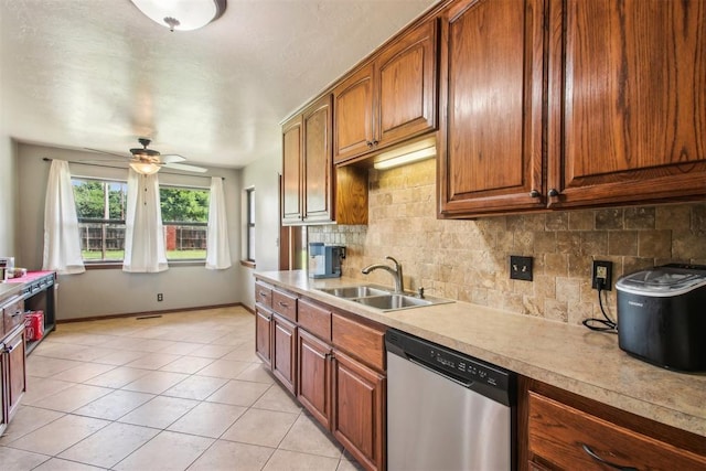 4211 Blue Sage Rd, Norman, OK 73072 - kitchen with stainless steel dishwasher, a sink, tasteful backsplash, ceiling fan, and light countertops