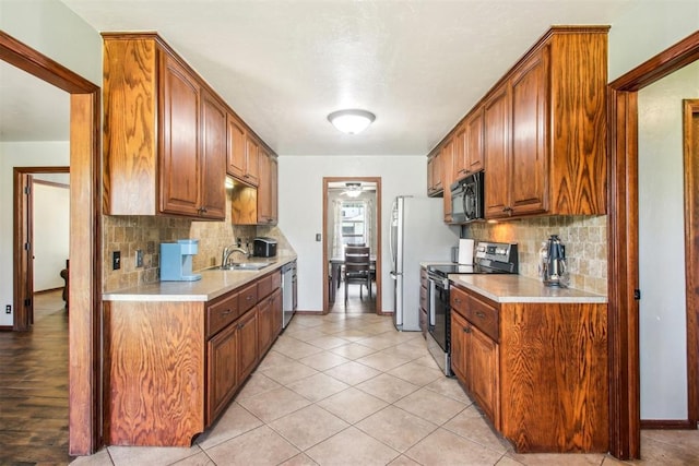 4211 Blue Sage Rd, Norman, OK 73072 - kitchen featuring appliances with stainless steel finishes, light countertops, decorative backsplash, and baseboards