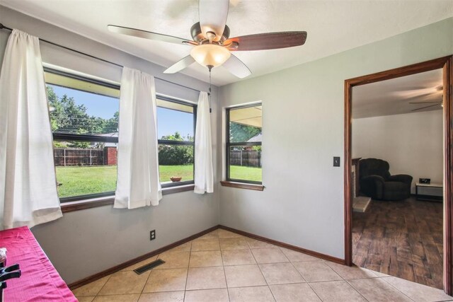 4211 Blue Sage Rd, Norman, OK 73072 - spare room with ceiling fan, light tile patterned floors, and baseboards