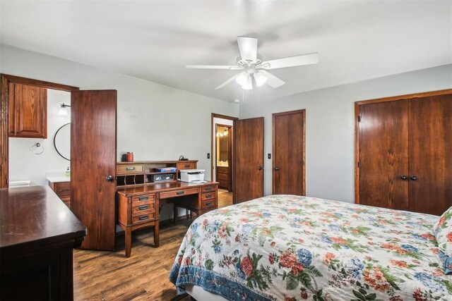 4211 Blue Sage Rd, Norman, OK 73072 - bedroom featuring wood finished floors, ensuite bath, two closets, and a ceiling fan