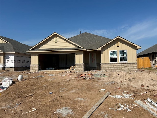 4306 Eloise Dr, Shawnee, OK 74804 - property under construction with brick siding, a garage, board and batten siding, and a shingled roof