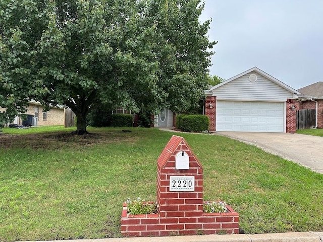 2220 Gray Dove Dr, Shawnee, OK 74804 - view of property hidden behind natural elements with a garage, a front lawn, and brick siding