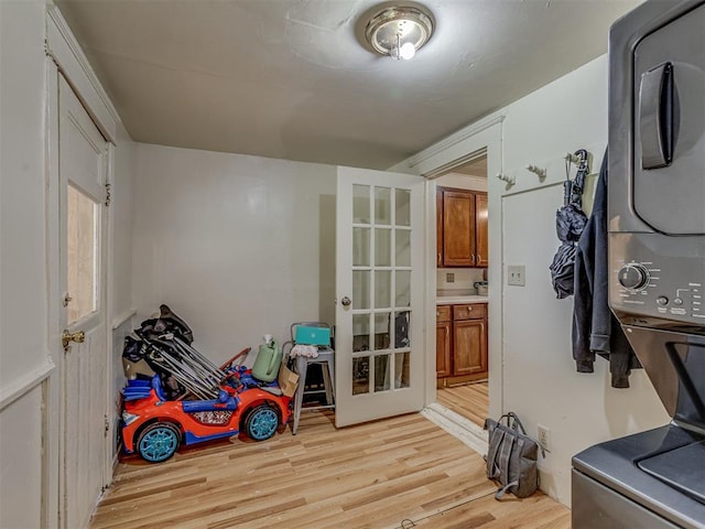 934 N Beard Ave, Shawnee, OK 74801 - rec room with stacked washer / dryer, light wood finished floors, and french doors