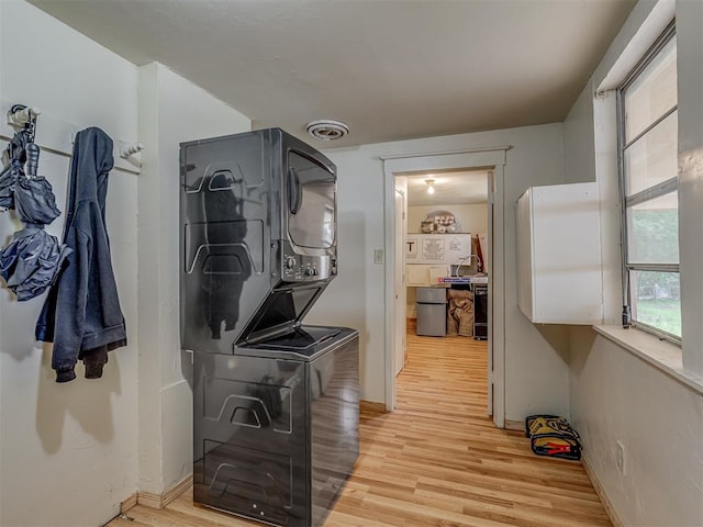 934 N Beard Ave, Shawnee, OK 74801 - laundry area featuring stacked washer / drying machine, light wood-style floors, and baseboards