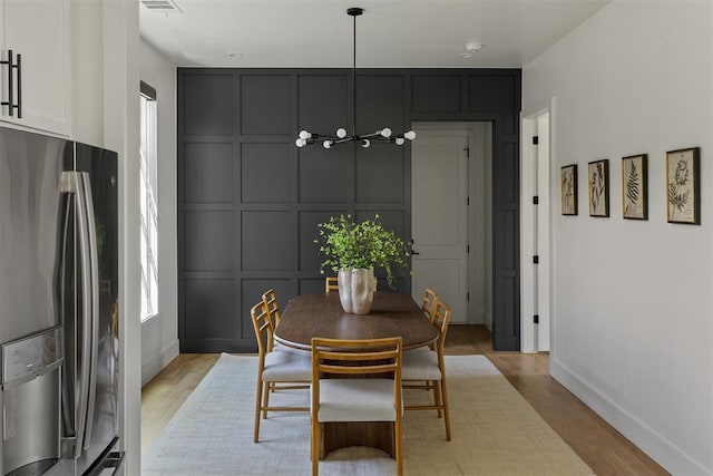 1801 Runway Blvd, Oklahoma City, OK 73108 - dining room with light wood-style floors and a decorative wall