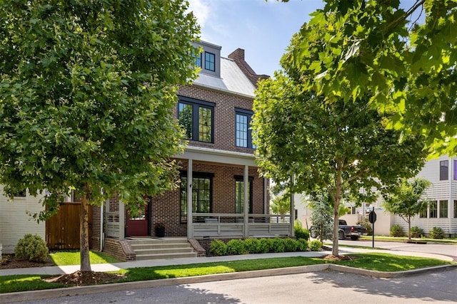 1801 Runway Blvd, Oklahoma City, OK 73108 - view of front facade with covered porch, brick siding, and a chimney