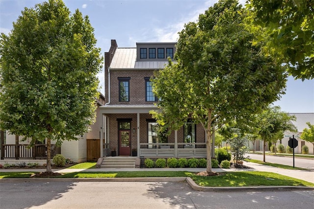 1801 Runway Blvd, Oklahoma City, OK 73108 - view of front of property featuring brick siding, covered porch, a standing seam roof, a metal roof, and a chimney