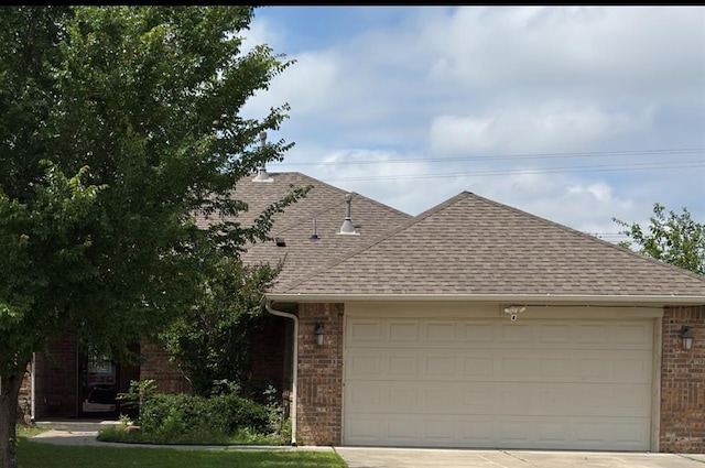 509 SW 149th Pl, Oklahoma City, OK 73170 - view of front of property featuring brick siding, roof with shingles, concrete driveway, and an attached garage