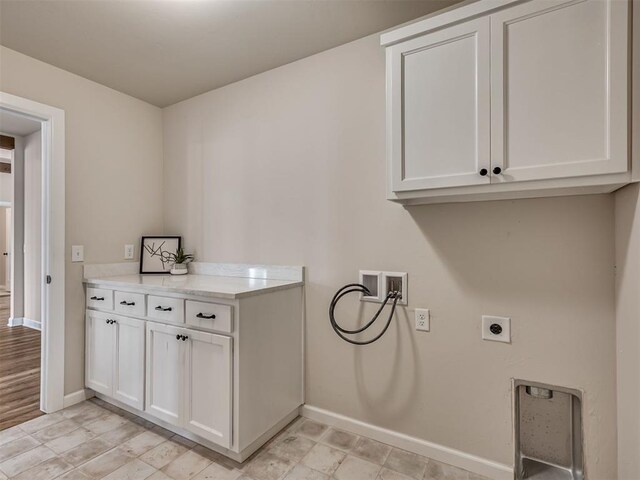 915 Kings Canyon Rd, Norman, OK 73071 - washroom featuring electric dryer hookup, cabinet space, baseboards, and washer hookup