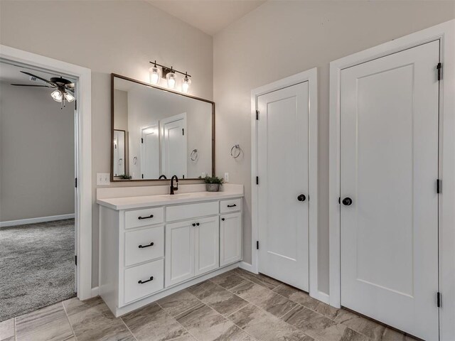 915 Kings Canyon Rd, Norman, OK 73071 - bathroom featuring a ceiling fan, vanity, and baseboards