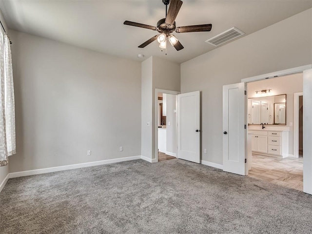 915 Kings Canyon Rd, Norman, OK 73071 - unfurnished bedroom with light carpet, baseboards, and ensuite bathroom