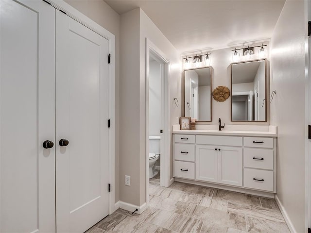 915 Kings Canyon Rd, Norman, OK 73071 - bathroom featuring vanity, baseboards, toilet, and marble finish floors