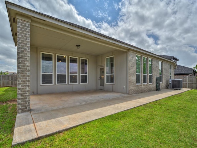 915 Kings Canyon Rd, Norman, OK 73071 - back of house with cooling unit, brick siding, and a patio area