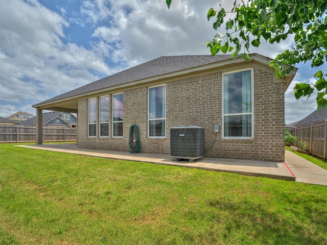 915 Kings Canyon Rd, Norman, OK 73071 - back of property featuring a patio, central air condition unit, and brick siding