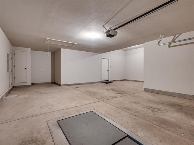 915 Kings Canyon Rd, Norman, OK 73071 - garage featuring a garage door opener, electric panel, and baseboards