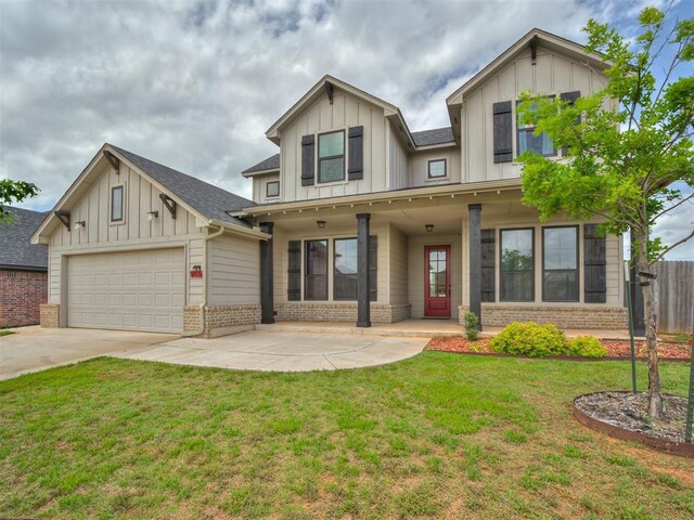 915 Kings Canyon Rd, Norman, OK 73071 - view of front of home with brick siding, board and batten siding, an attached garage, and driveway
