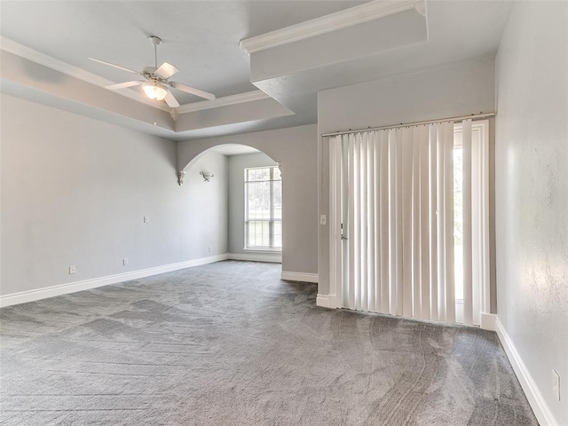 1031 Hidden Valley Ln, Choctaw, OK 73020 - unfurnished room with carpet, arched walkways, a raised ceiling, ornamental molding, and ceiling fan