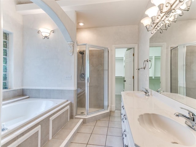 1031 Hidden Valley Ln, Choctaw, OK 73020 - bathroom featuring a bath, a shower stall, tile patterned flooring, double vanity, and a chandelier