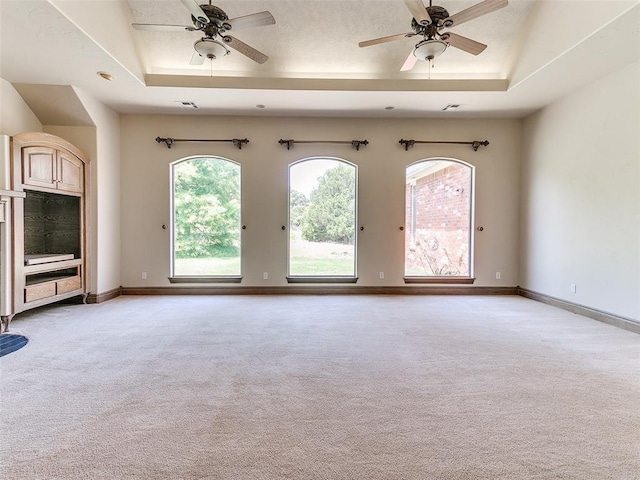 1031 Hidden Valley Ln, Choctaw, OK 73020 - unfurnished room featuring a ceiling fan, light colored carpet, and a raised ceiling