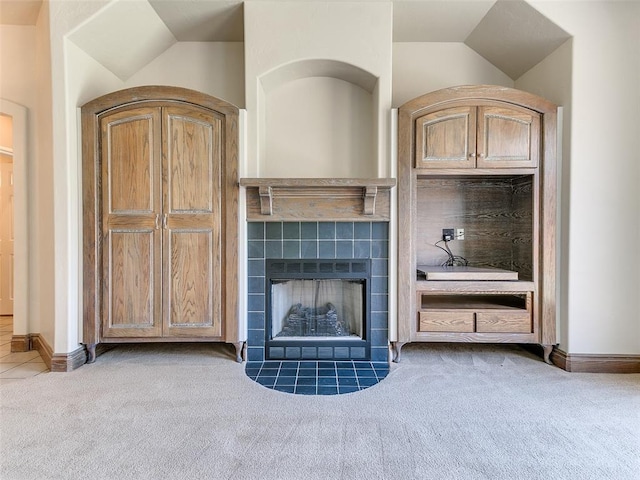1031 Hidden Valley Ln, Choctaw, OK 73020 - unfurnished living room with carpet flooring, a tile fireplace, and vaulted ceiling
