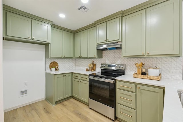 2800 NW 43rd St, Oklahoma City, OK 73112 - kitchen with green cabinetry, stainless steel range with electric cooktop, under cabinet range hood, light countertops, and light wood-style flooring