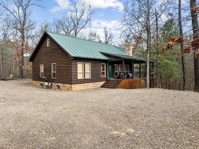 184 Almond Ln, Hochatown, OK 74728 - view of front of house featuring covered porch, a standing seam roof, metal roof, a chimney, and gravel driveway