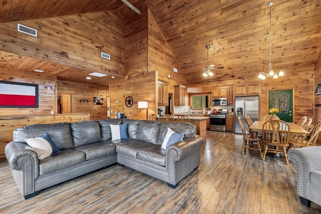 184 Almond Ln, Hochatown, OK 74728 - living area with wood walls, high vaulted ceiling, wooden ceiling, wood finished floors, and a chandelier