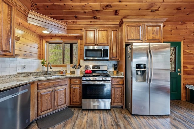 184 Almond Ln, Hochatown, OK 74728 - kitchen featuring stainless steel appliances, wooden ceiling, a sink, brown cabinetry, and dark wood-style floors