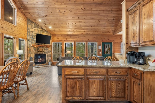 184 Almond Ln, Hochatown, OK 74728 - kitchen with plenty of natural light, wood ceiling, a peninsula, wood walls, and brown cabinets