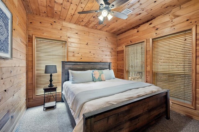 184 Almond Ln, Hochatown, OK 74728 - carpeted bedroom featuring wooden walls, wood ceiling, and a ceiling fan