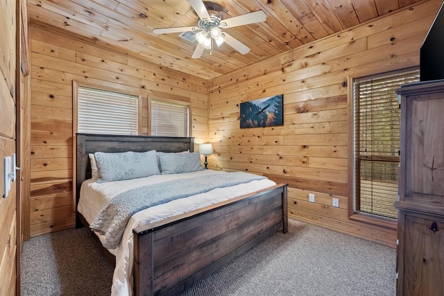 184 Almond Ln, Hochatown, OK 74728 - carpeted bedroom with wooden ceiling, wood walls, and ceiling fan