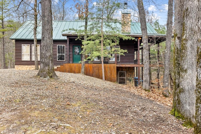 184 Almond Ln, Hochatown, OK 74728 - view of front of home with a chimney, a standing seam roof, and metal roof