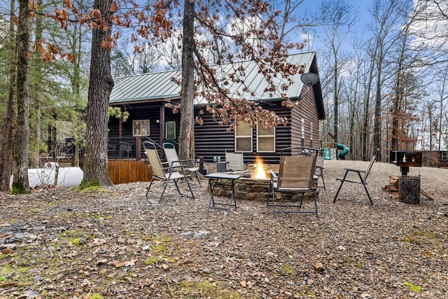 184 Almond Ln, Hochatown, OK 74728 - back of property featuring a fire pit, metal roof, and a standing seam roof