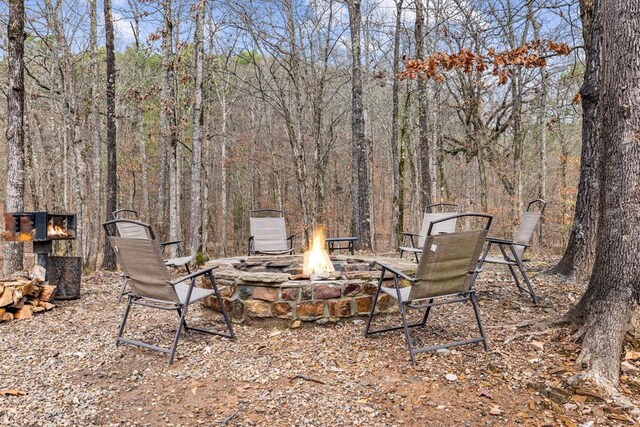 184 Almond Ln, Hochatown, OK 74728 - view of yard with a fire pit and a wooded view