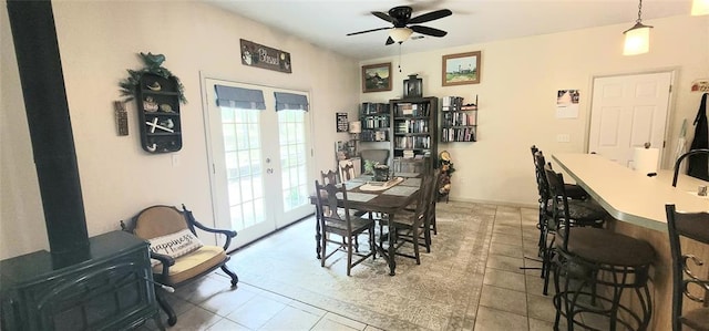 319 W Cedar Ln, Minco, OK 73059 - tiled dining space with a ceiling fan, french doors, and a wood stove