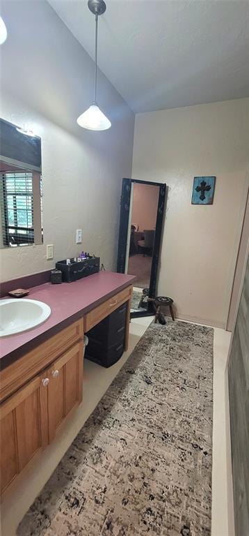 319 W Cedar Ln, Minco, OK 73059 - bathroom featuring vanity and vaulted ceiling