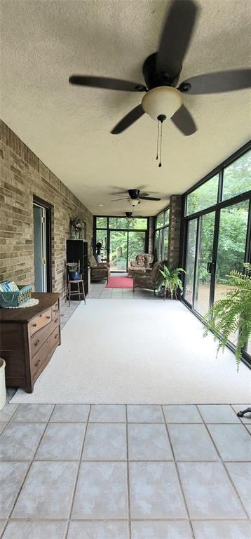 319 W Cedar Ln, Minco, OK 73059 - sunroom / solarium featuring tile patterned flooring, a textured ceiling, carpet, and a wall of windows