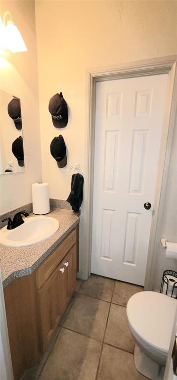 319 W Cedar Ln, Minco, OK 73059 - bathroom with vanity, tile patterned floors, and toilet