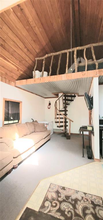 319 W Cedar Ln, Minco, OK 73059 - unfurnished living room featuring stairs, wooden ceiling, and tile patterned floors