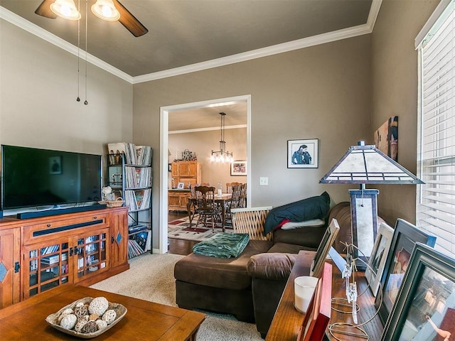 913 E Harrison Ave, Guthrie, OK 73044 - carpeted living room featuring ceiling fan, crown molding, healthy amount of natural light, and a chandelier