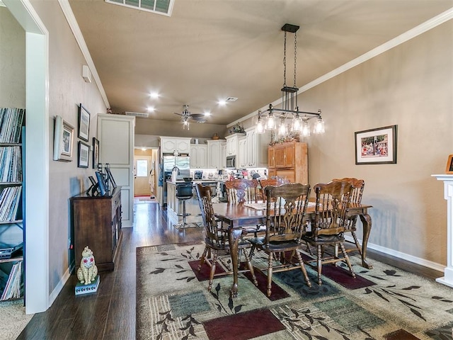 913 E Harrison Ave, Guthrie, OK 73044 - dining room with ornamental molding, baseboards, dark wood-style floors, and ceiling fan