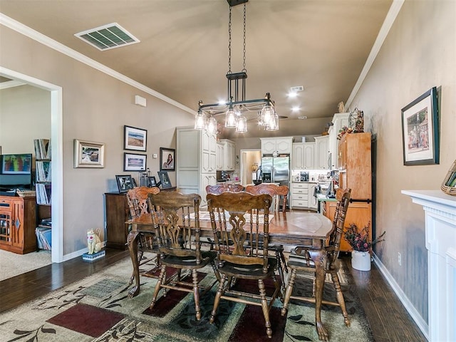 913 E Harrison Ave, Guthrie, OK 73044 - dining space featuring dark wood-style flooring, ornamental molding, and baseboards