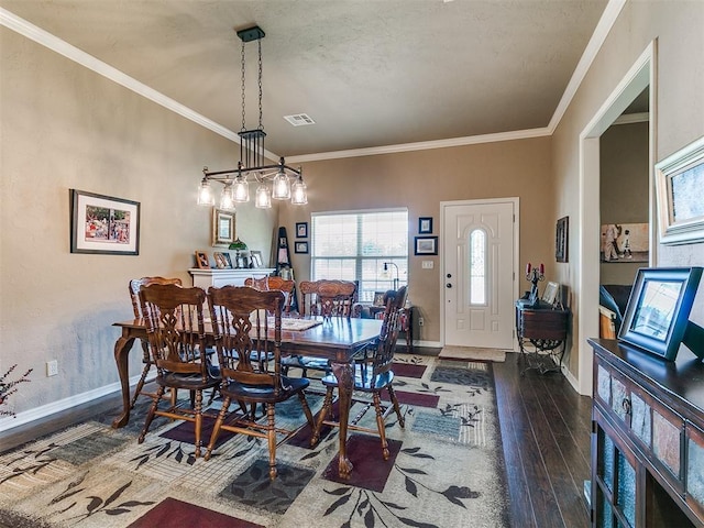 913 E Harrison Ave, Guthrie, OK 73044 - dining room with dark wood-style flooring, healthy amount of natural light, baseboards, and crown molding