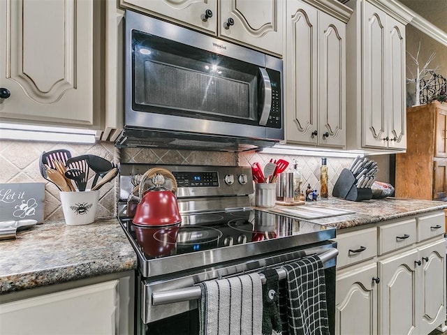 913 E Harrison Ave, Guthrie, OK 73044 - kitchen featuring appliances with stainless steel finishes and tasteful backsplash