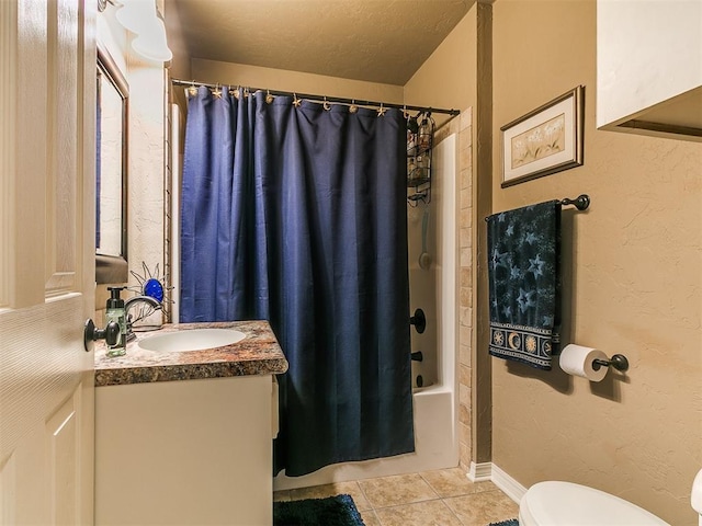 913 E Harrison Ave, Guthrie, OK 73044 - bathroom featuring tile patterned flooring, vanity, toilet, and shower / tub combo with curtain