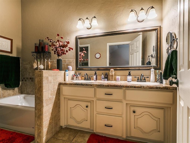 913 E Harrison Ave, Guthrie, OK 73044 - full bath featuring double vanity, tile patterned floors, a garden tub, and tile walls